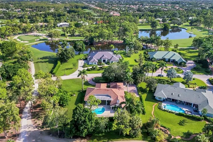 Aerial overview of property's location with a golf club, a large body of water, and nearby suburban area