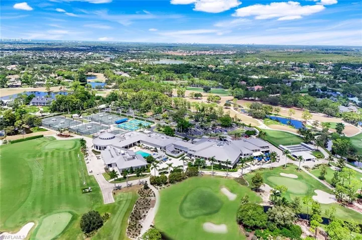 View of property location featuring a local golf course and a nearby body of water