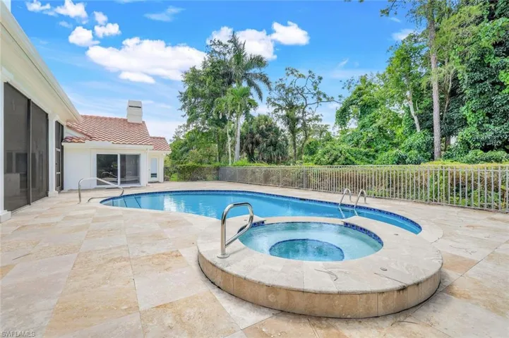 View of pool featuring a patio and a pool with connected hot tub