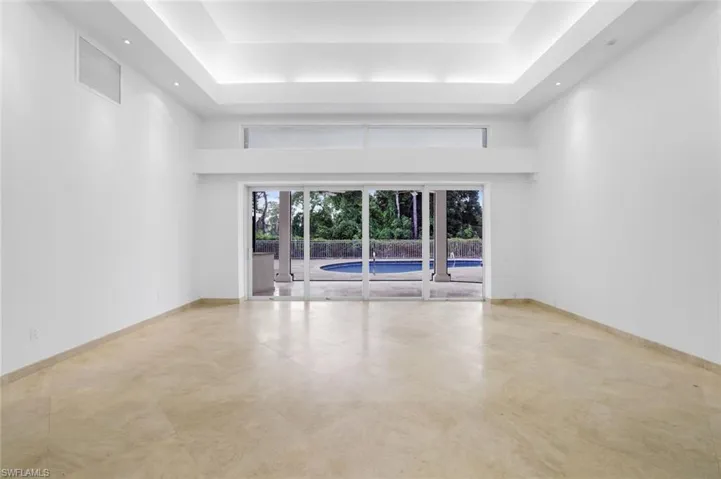 Spare room featuring a raised ceiling and a high ceiling