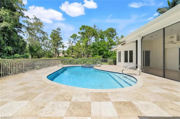 View of pool featuring a patio area, a pool with connected hot tub, and a ceiling fan