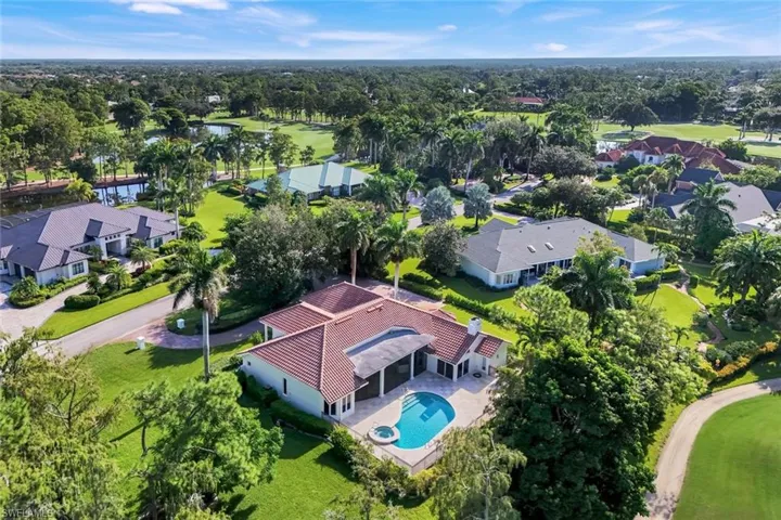Aerial perspective of suburban area with a pool area and a golf course