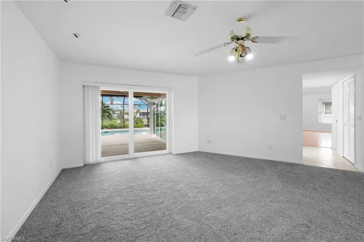 Formal living room with great room, bar and kitchen to the right