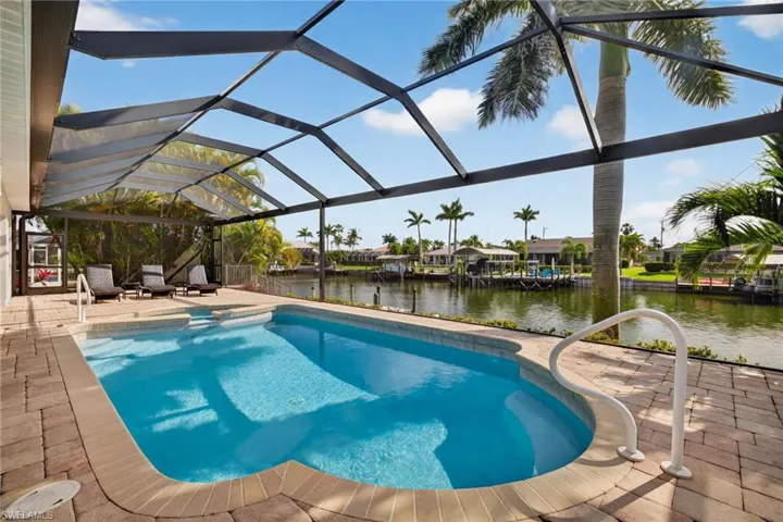 Swimming pool with a spa and a view! The large patio area is amazing!