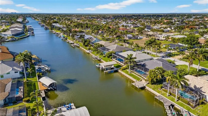 Aerial view of residential area featuring a large body of water