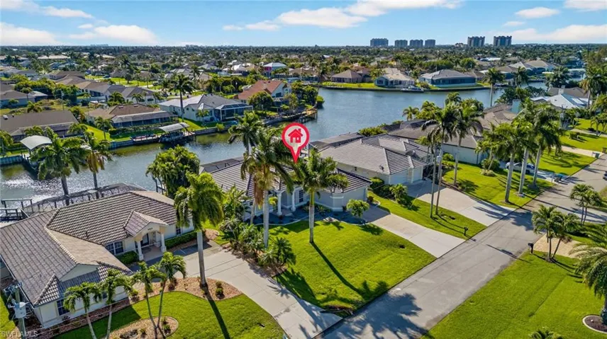 Aerial perspective of suburban area featuring a large body of water