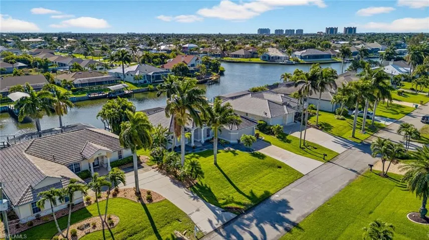 Aerial view of residential area featuring a nearby body of water