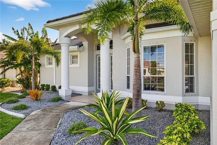 View of exterior entry featuring stucco siding