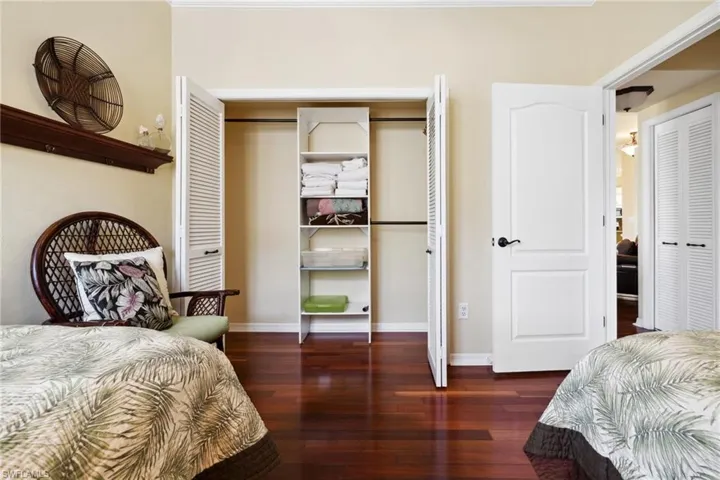 Bedroom with baseboards and wood finished floors