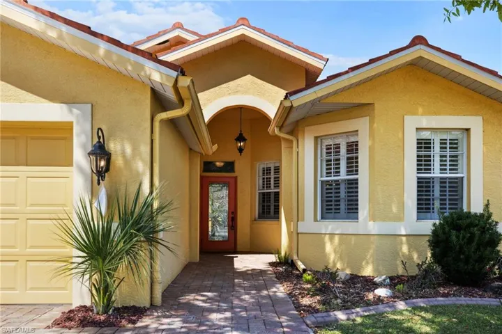 Property entrance with stucco siding and a garage
