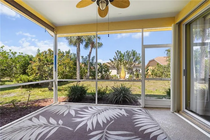 Unfurnished sunroom with a wealth of natural light and ceiling fan