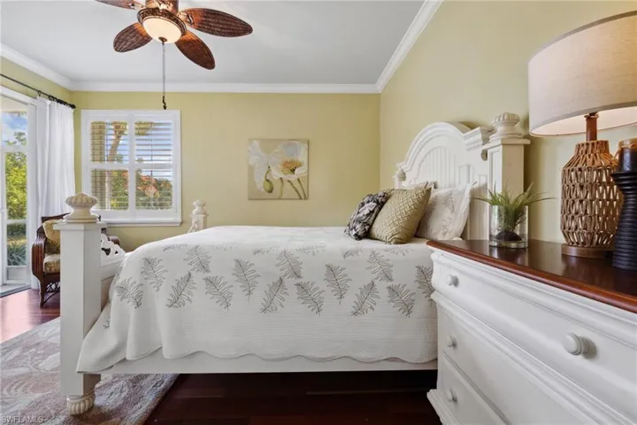 Bedroom featuring crown molding, wood finished floors, and ceiling fan