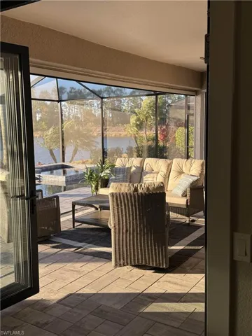 Sunroom / solarium featuring a water view