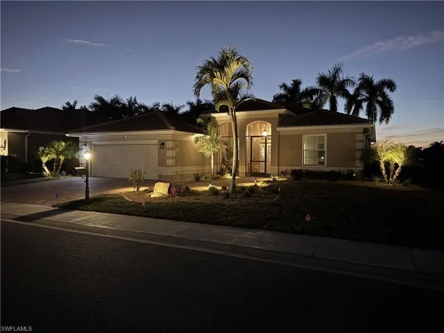 Mediterranean / spanish house featuring driveway, a tiled roof, a garage, and stucco siding