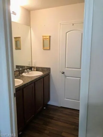 Bathroom featuring double sink vanity and hardwood / wood-style floors