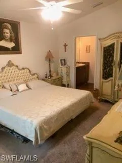 Bedroom featuring lofted ceiling, dark carpet, and ceiling fan