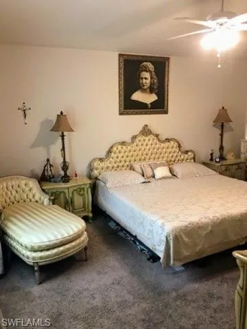 Bedroom with ceiling fan and carpet flooring
