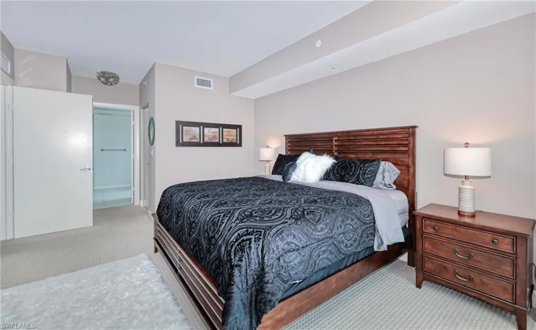 Bedroom featuring light carpet