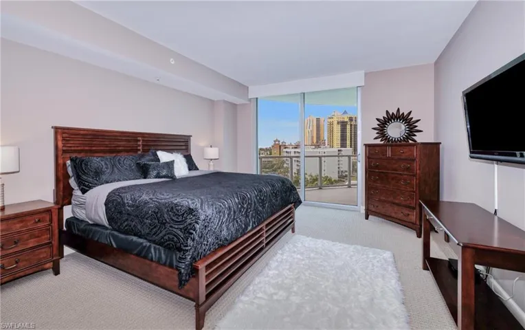 Carpeted bedroom featuring access to outside