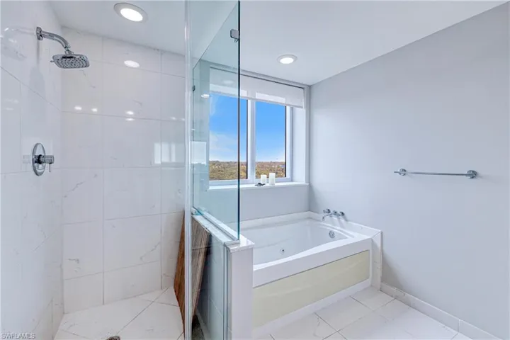 Bathroom with independent shower and bath and tile patterned flooring