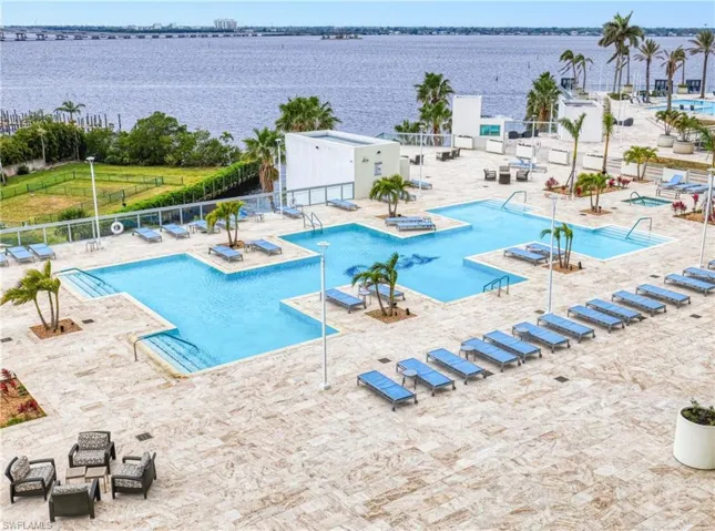 View of pool featuring a patio and a water view