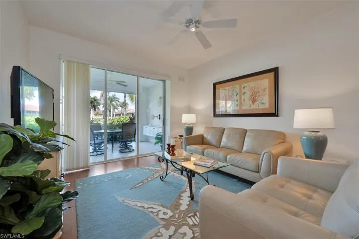 Living room featuring ceiling fan and wood-type flooring