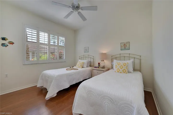 Bedroom featuring ceiling fan and dark hardwood / wood-style flooring