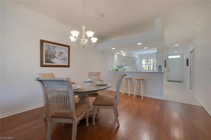 Tiled dining space featuring a notable chandelier