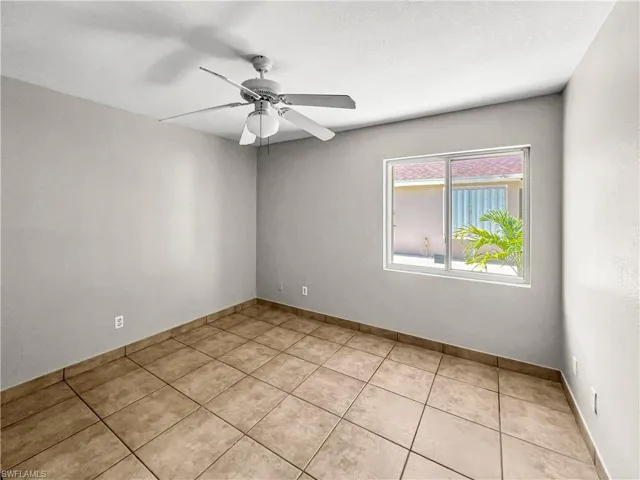 Neutral-toned walls complement the brown tile flooring, creating a versatile interior space