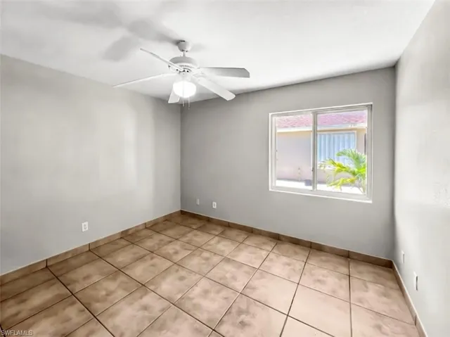 Neutral-toned walls complement the square tile flooring throughout this space