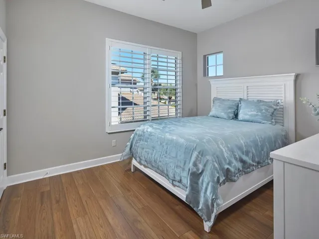 Bedroom featuring dark wood-style flooring and a ceiling fan