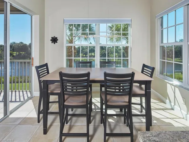 Dining space with a water view and light tile patterned floors