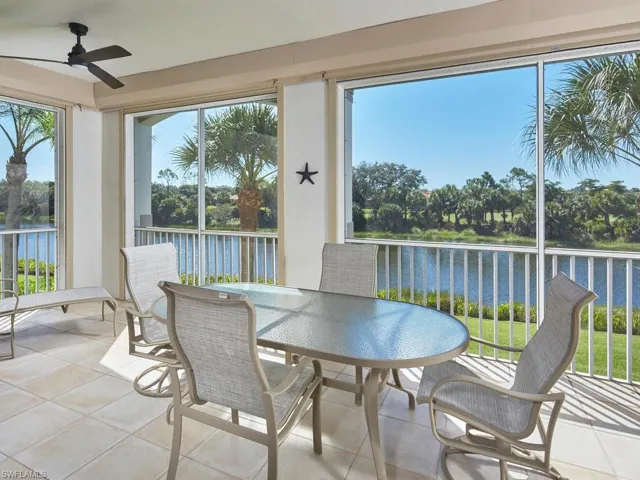 Sunroom with a water view and tile patterned floors