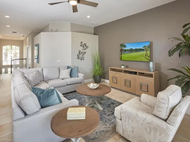 Living area with light tile patterned floors, recessed lighting, and a ceiling fan