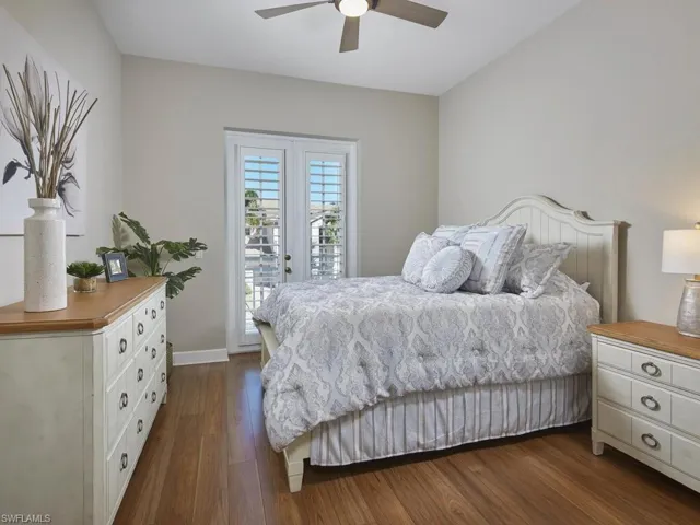 Bedroom featuring dark wood-style floors, access to exterior, and ceiling fan