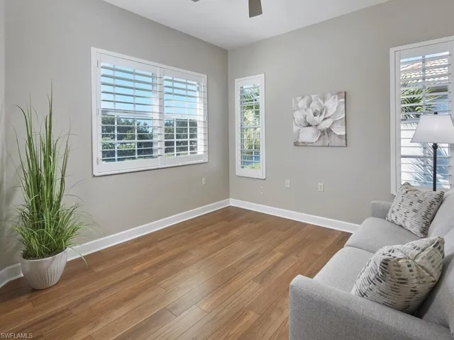 Living area with wood finished floors and ceiling fan