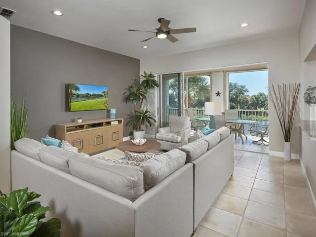 Living area with light tile patterned floors, recessed lighting, and a ceiling fan