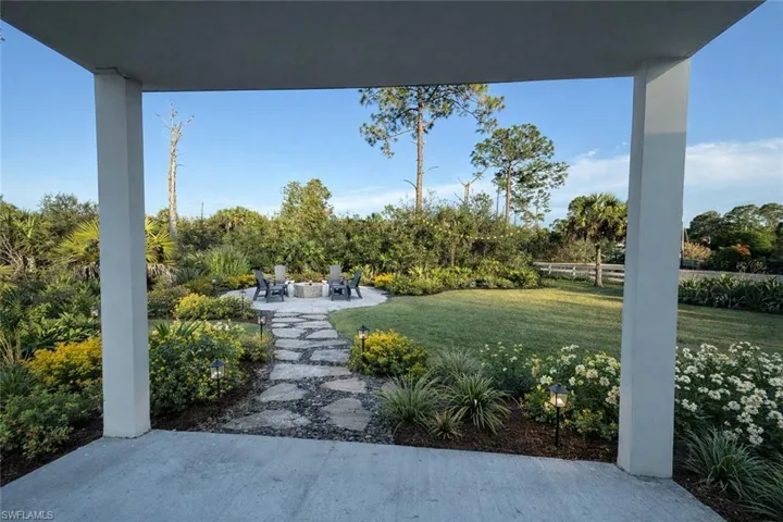 View of yard featuring a patio area and an outdoor fire pit