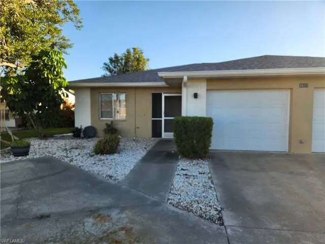 Ranch-style house featuring concrete driveway, a garage, stucco siding, and a shingled roof