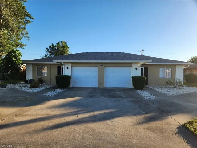 Ranch-style house featuring stucco siding, driveway, an attached garage, and a shingled roof
