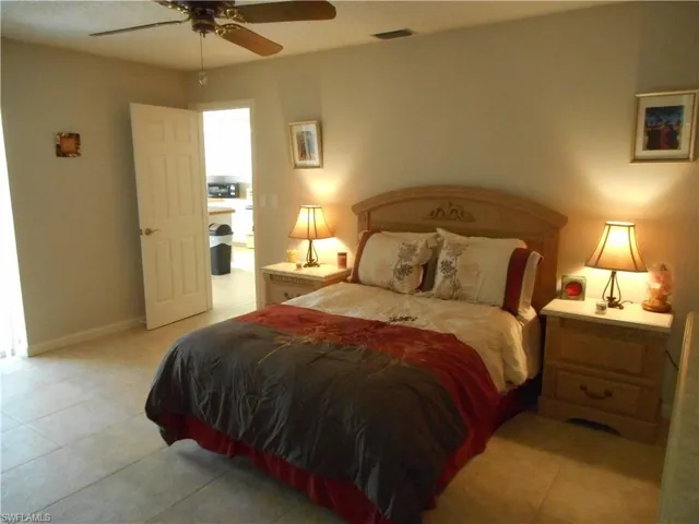Bedroom featuring light tile patterned floors and a ceiling fan