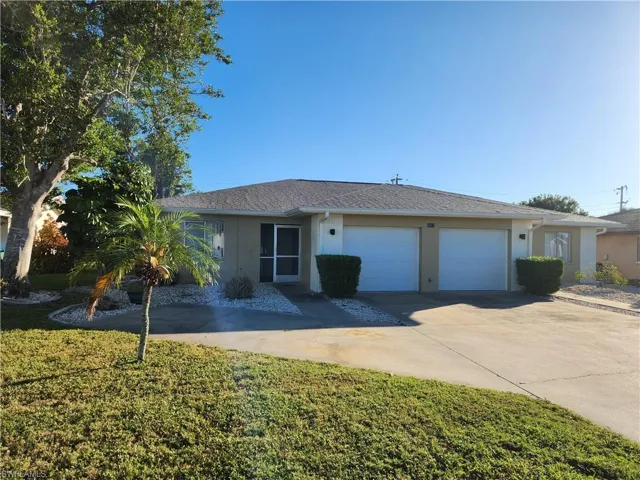 Ranch-style home featuring stucco siding, concrete driveway, a front yard, and an attached garage