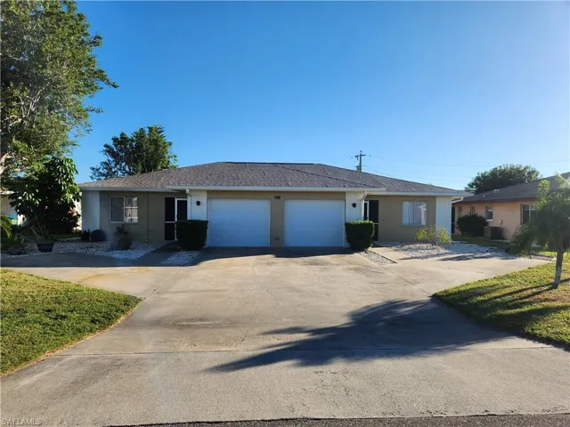 Ranch-style house with stucco siding, driveway, and a garage