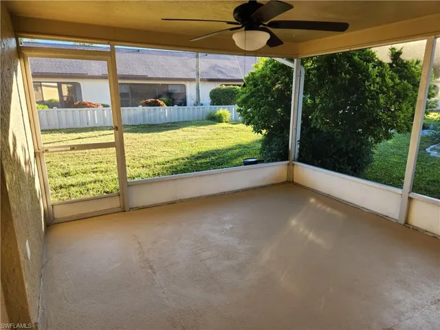 Unfurnished sunroom featuring ceiling fan and healthy amount of natural light
