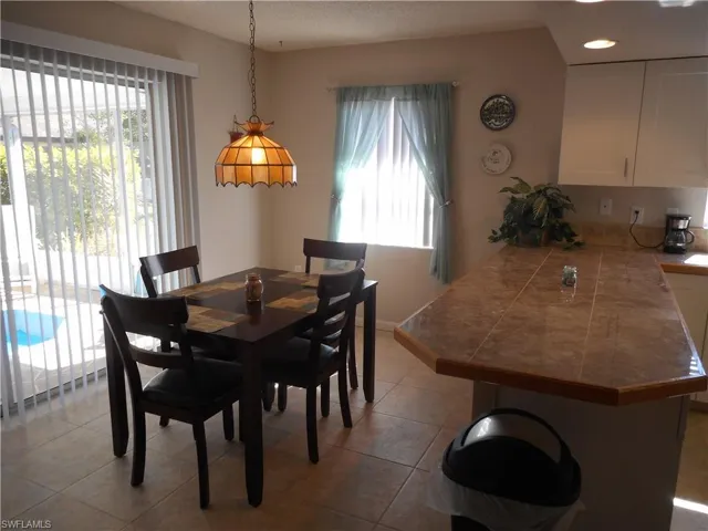 Dining space featuring tile patterned floors and recessed lighting