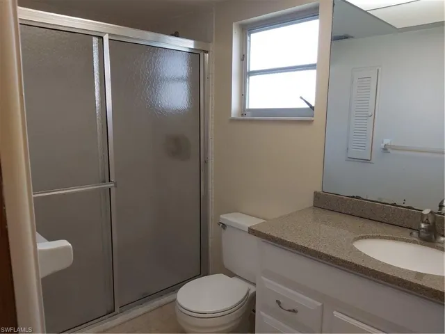 Full bathroom with a stall shower and vanity