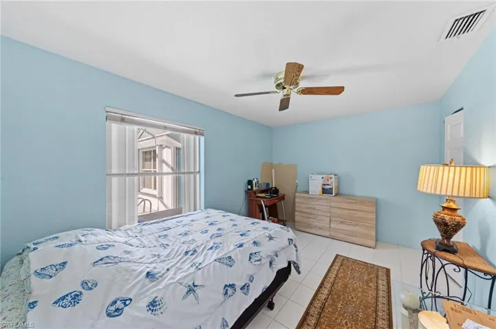 Bright room with white tile flooring and light blue walls