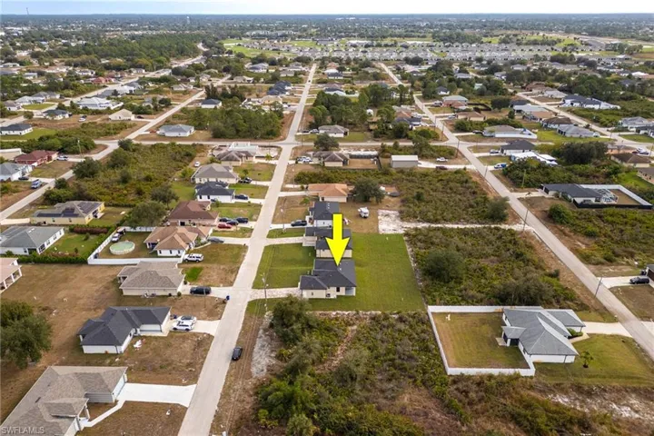 Aerial overview of property's location featuring nearby suburban area