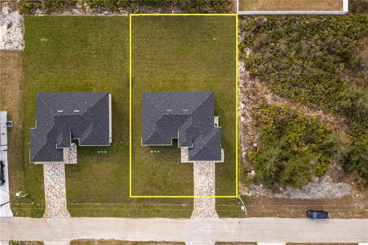 Aerial view of property and surrounding area featuring property boundaries highlighted