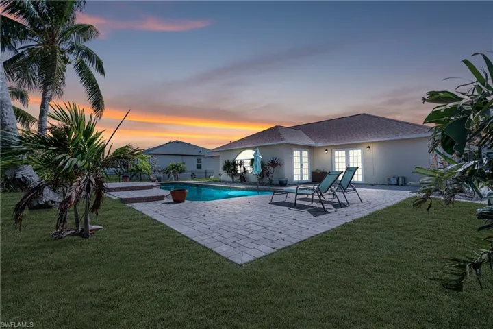 View of swimming pool featuring french doors, a patio area, and a yard